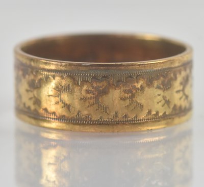 Lot 1243 - A 9ct yellow gold wedding band, with engraved...