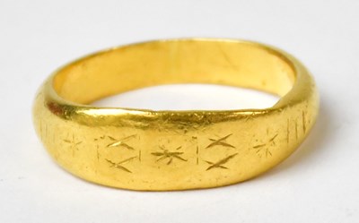 Lot 987 - A Chinese 24ct yellow gold ring with engraved...