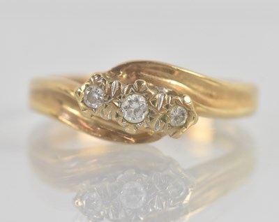 Lot 1237 - A 9ct yellow gold diamond three stone ring,...