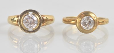 Lot 1216 - Two 9ct yellow gold white stone solitaire...
