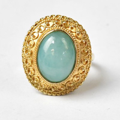 Lot 1017 - A 9ct yellow gold ring set with an oval jade...
