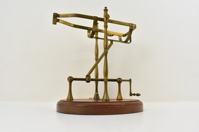 Lot 527 - A brass bottle pourer with handle and screw...