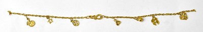 Lot 1043 - A Chinese 24ct yellow gold charm bracelet, set...