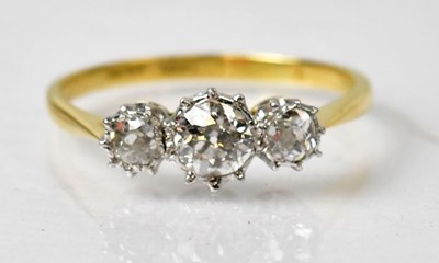 Lot 1005 - An 18ct yellow gold and Platinum three stone...