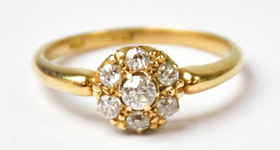 Lot 1000 - An 18ct yellow gold ring set with a cluster of...