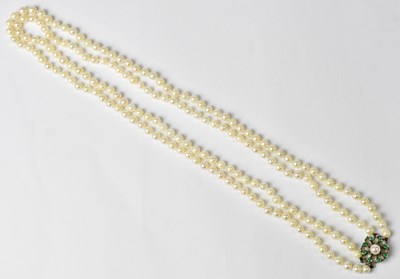 Lot 1109 - A double-strand pearl necklace with a white...