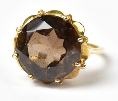 Lot 1019 - A 9ct yellow gold ring set with a round smoky...