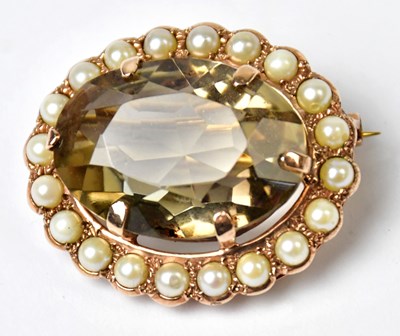 Lot 1076 - A yellow metal brooch set with an oval smoky...