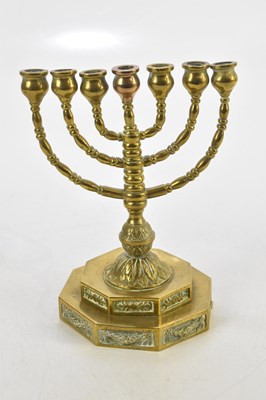 Lot 1184 - A brass menorah on stepped base, height 17cm.
