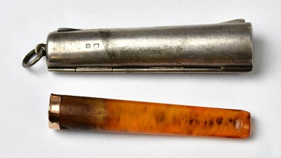 Lot 743 - An amber cheroot holder with a 9ct rose gold...
