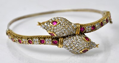 Lot 1063 - A yellow and white metal hinged bangle, in the...