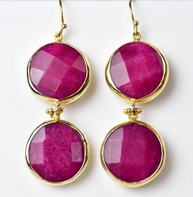 Lot 1115 - A pair of drop earrings set with circular...