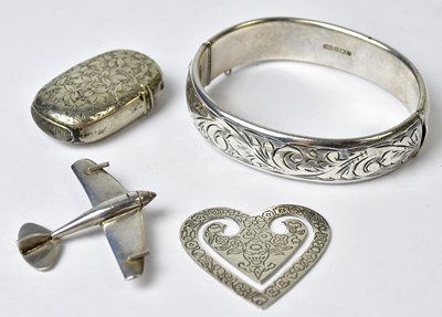 Lot 1131 - A hallmarked silver hinged bangle with foliate...
