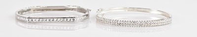 Lot 1041 - Two sterling silver hinged snap bangles set...