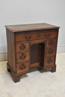 Lot 70 - An early 19th century oak kneehole desk, with...