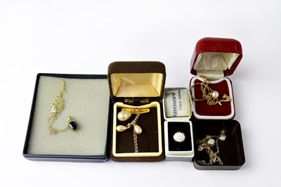 Lot 1210 - A 9ct gold bracelet with a saxophone pendant...