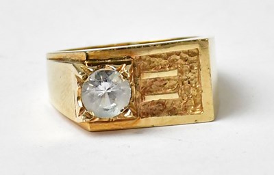 Lot 1027 - A 1970s 9ct yellow gold ring set with a white...