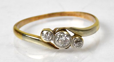 Lot 1034 - A yellow metal ring set with three diamonds,...