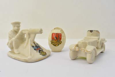 Lot 573 - Three crested ware military themed ornaments,...