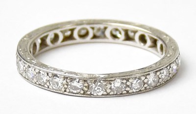 Lot 1033 - A white metal eternity ring set with diamonds,...