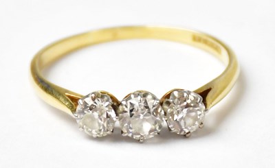 Lot 1003 - An 18ct yellow gold ring set with three...