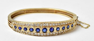Lot 1062 - A yellow gold diamond and sapphire hinged...