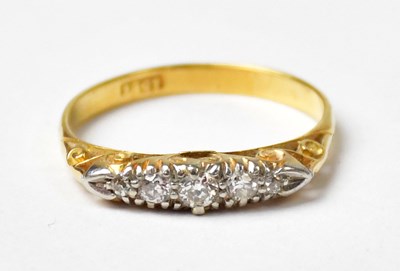Lot 1002 - An 18ct yellow gold ring set with five...