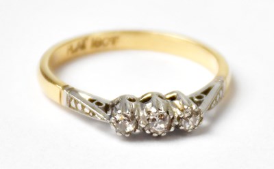 Lot 1011 - An 18ct yellow gold ring set with three...