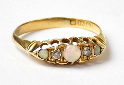 Lot 1013 - An 18ct yellow gold ring set with three opals...