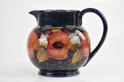 Lot 40 - WILLIAM MOORCROFT; a baluster shaped jug in...