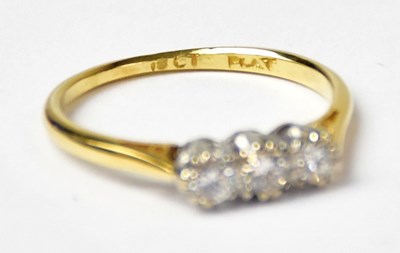 Lot 1001 - An 18ct yellow gold ring set with three...