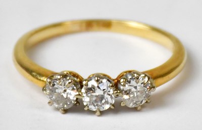 Lot 1007 - An 18ct yellow gold ring set with three...
