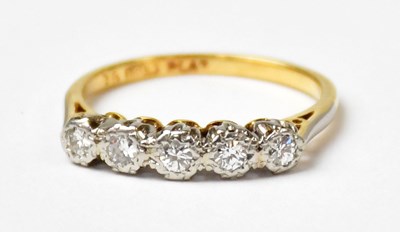 Lot 689 - An 18ct yellow gold ring set with five...