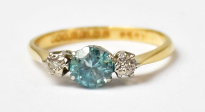 Lot 998 - An 18ct yellow gold ring set with a pale blue...