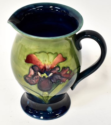 Lot 112 - MOORCROFT; an 'Iris' pattern jug of blue and...