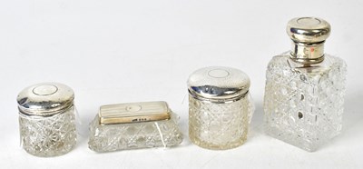 Lot 725 - Four Edwardian and later silver-topped cut...