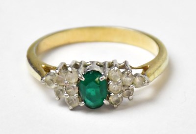Lot 1035 - A yellow metal ring set with a central oval...