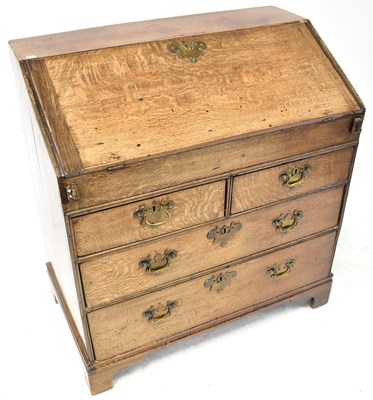 Lot 90 - A George III oak bureau with fall front and...