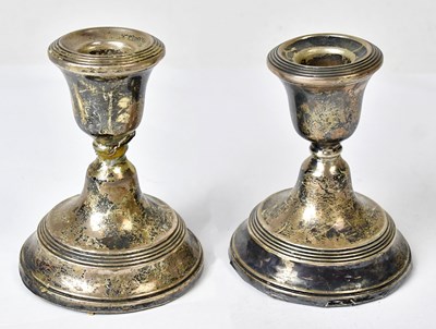 Lot 707 - A pair of George V squat silver candlesticks,...