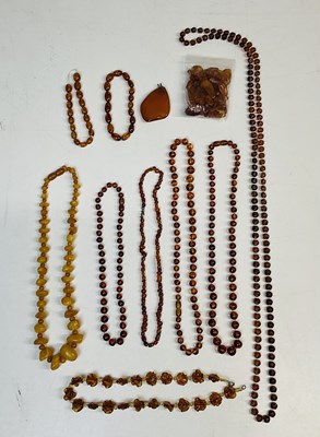 Lot 784 - A group of amber coloured bead necklaces, also...