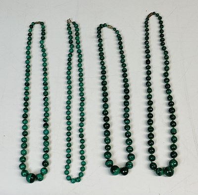 Lot 785 - Four malachite bead necklaces, one with 9ct...