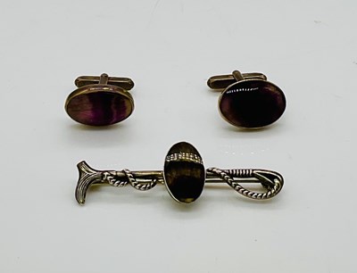 Lot 668 - A white metal riding crop brooch, later...