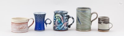 Lot 752 - A group of stoneware and slipware mugs by...