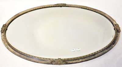 Lot 71 - A silver-plated oval wall hanging mirror, with...