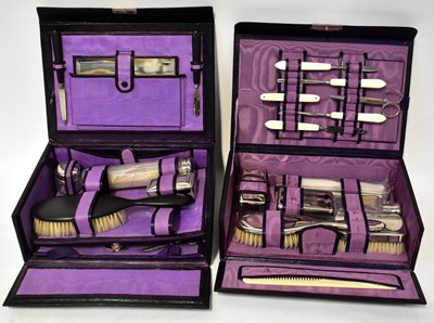 Lot 411 - Two cased travelling vanity sets in vinyl...