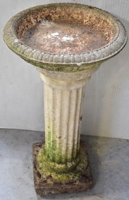 Lot 79 - A reconstitued stone birdbath, on a fluted...