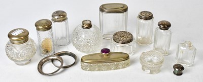 Lot 727 - A collection of cut glass silver topped...