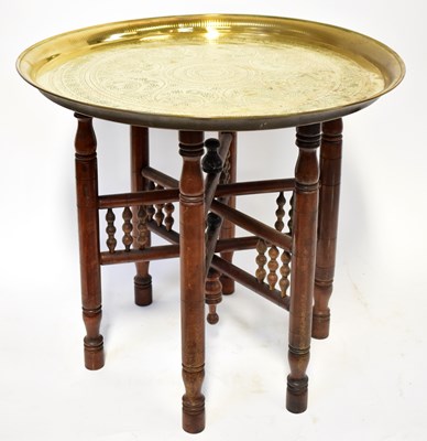 Lot 230 - An Islamic brass tray with embossed crescent...