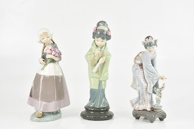 Lot 1756 - LLADRO; a group of three figures including two...