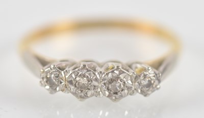 Lot 1323 - An 18ct yellow gold and platinum diamond four...